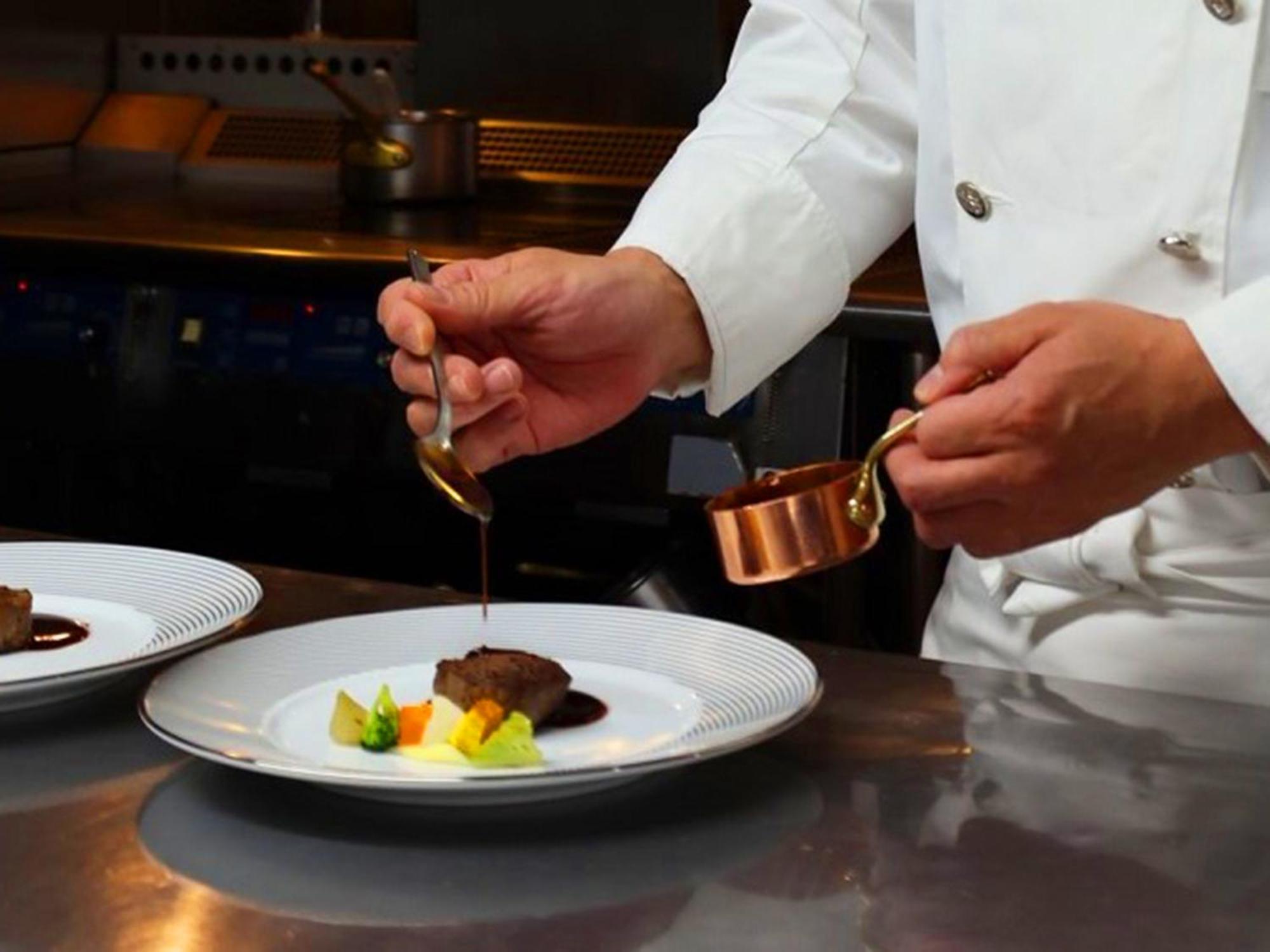 Shin Furano Prince Hotel Bagian luar foto A chef plating a dish